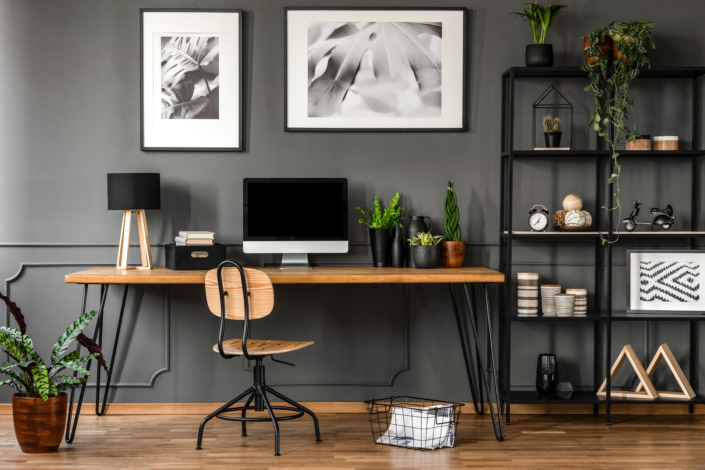 modern wooden desk and floor with green plants decor
